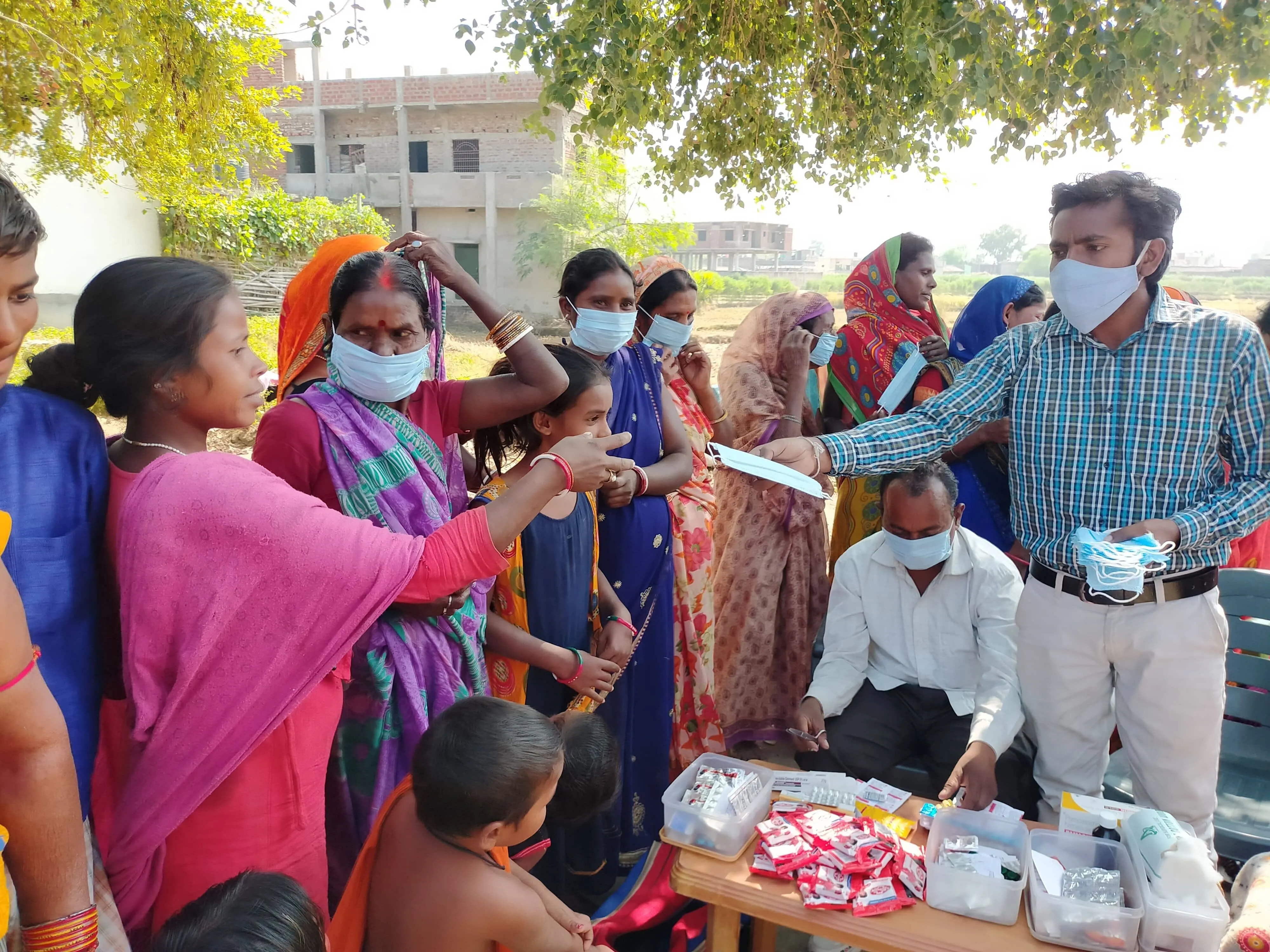 A Jeevan Deep worker distributing vitamins to villagers.