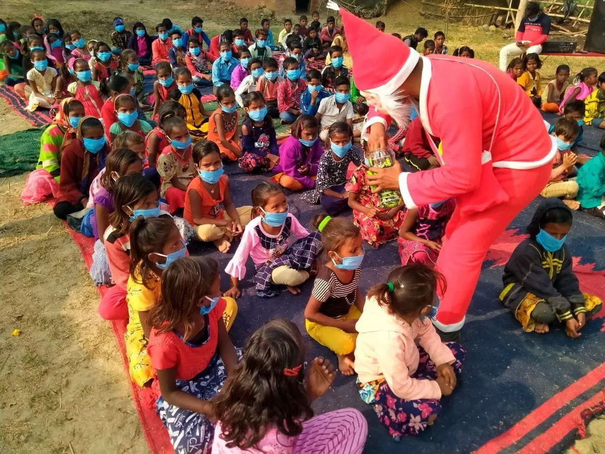 Children celebrating Christmas with Jeevan Deep volunteers.