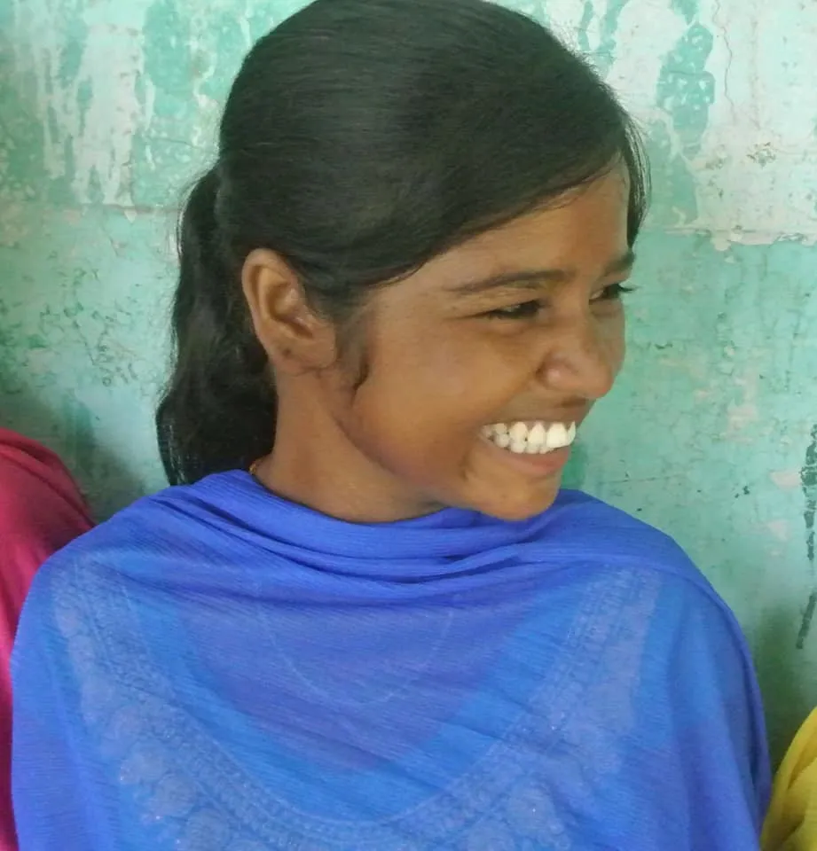 A woman concentrating on her sewing at the centre.