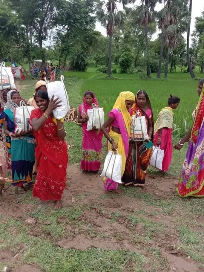 Women from a Bodhgaya village smile as they receive food parcels through the Jeevan Deep program.