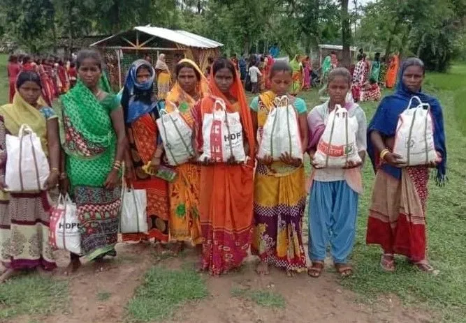 Women waiting in line for food at Arjunbigha village.